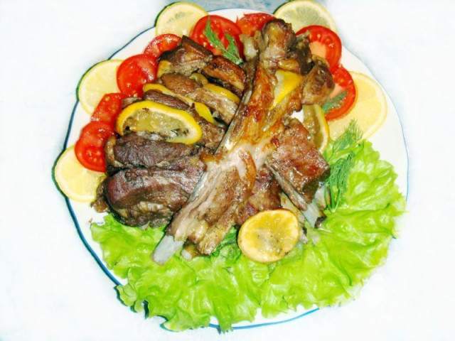 Lamb ribs baked with lemon in the oven