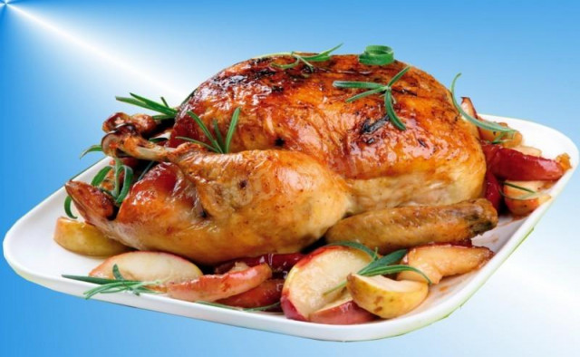 Whole chicken with apples in the oven