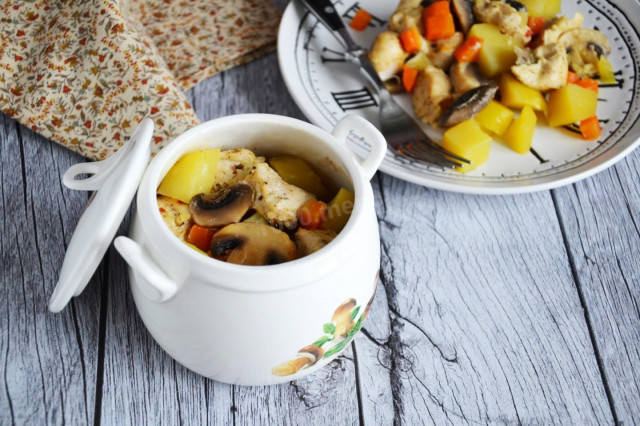 Chicken with mushrooms and potatoes in a pot