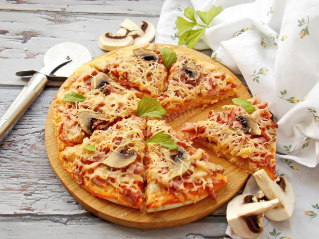 Pizza with sausage, mushrooms and cheese