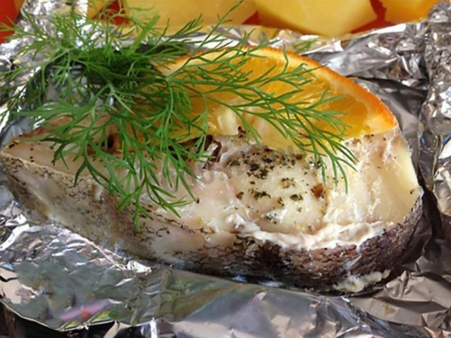 Cod steak in foil with garlic and oranges