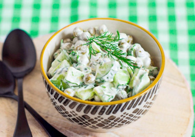 Salad with fresh cucumber, peas and sour cream