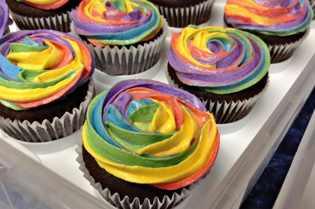 Classic chocolate cupcakes with different colored cream