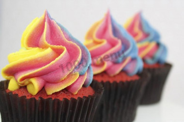 Classic chocolate cupcakes with different colored cream