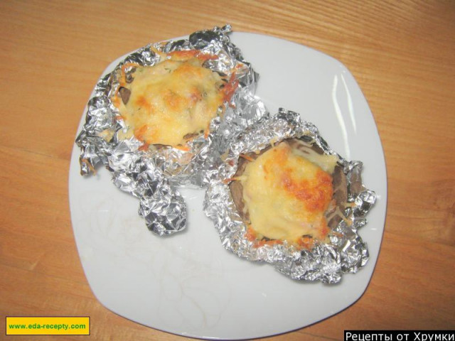 Baked potatoes in foil in sour cream