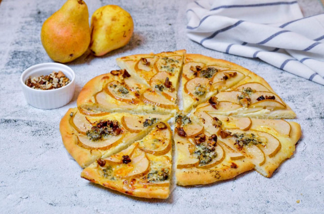 Thin pizza with cheese with mouldy mozzarella and pears