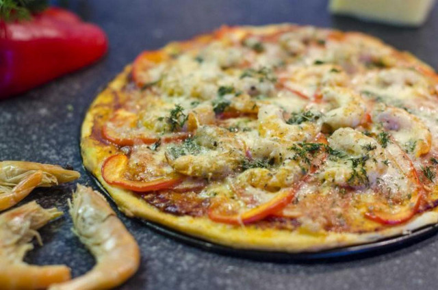 Homemade pizza with king prawns and tomato paste