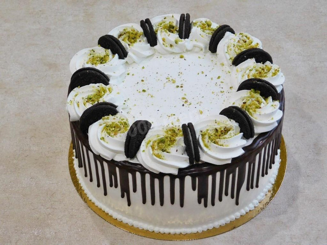 Cake with nuts, prunes, sour cream and cream