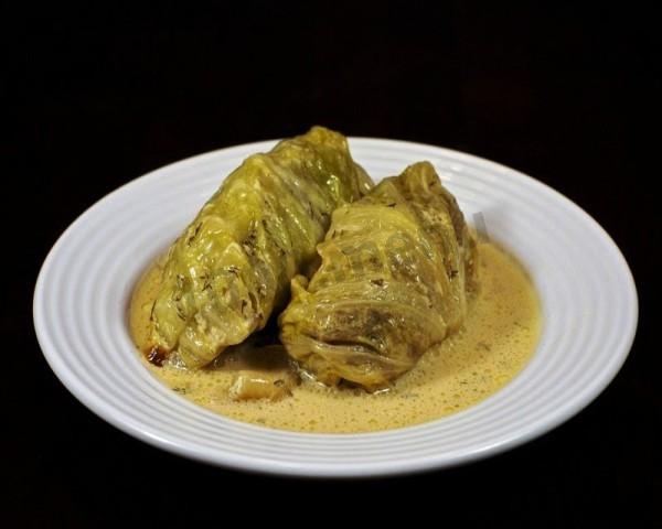 Cabbage rolls baked in sour cream with with a bow