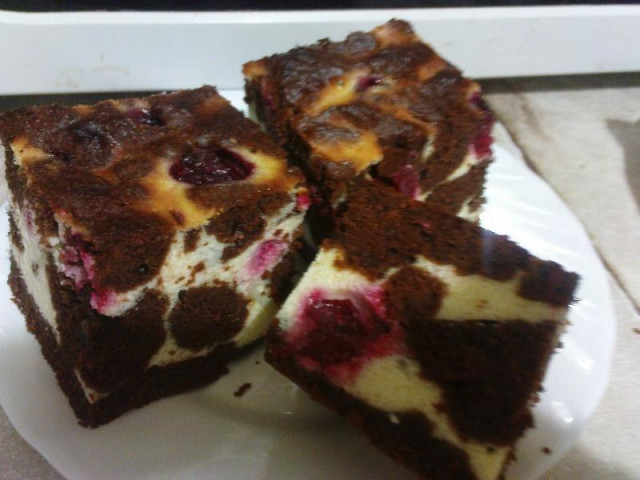 Chocolate brownie with cottage cheese and cherries and vanilla