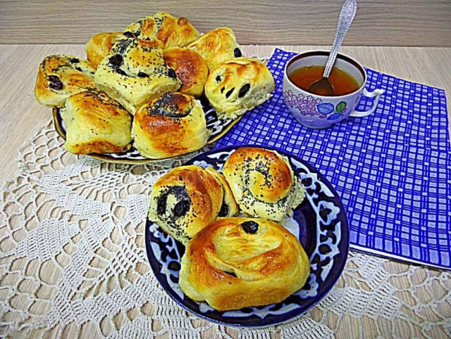 Buns with raisins and poppy seeds on pastry