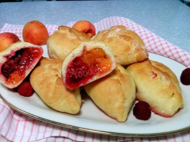 Yeast pies with apricots and raspberries