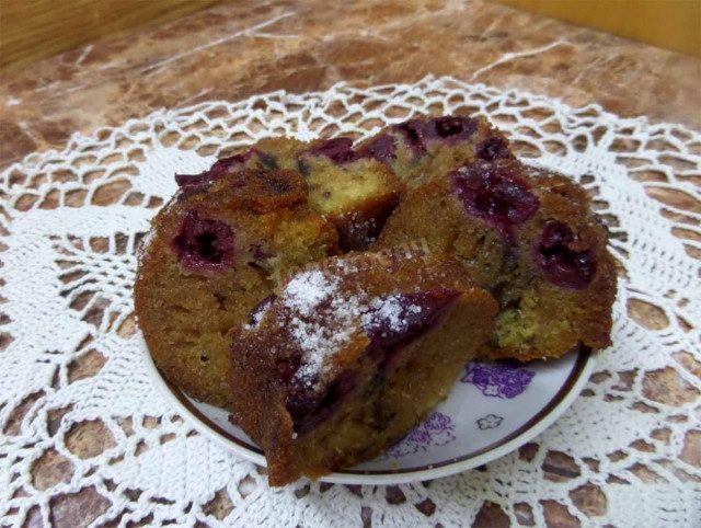 Cupcake with frozen cherries on curdled milk