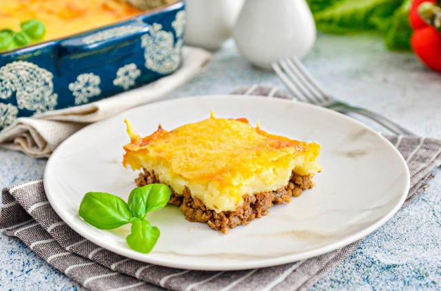 Potato casserole with minced meat and cheese in oven