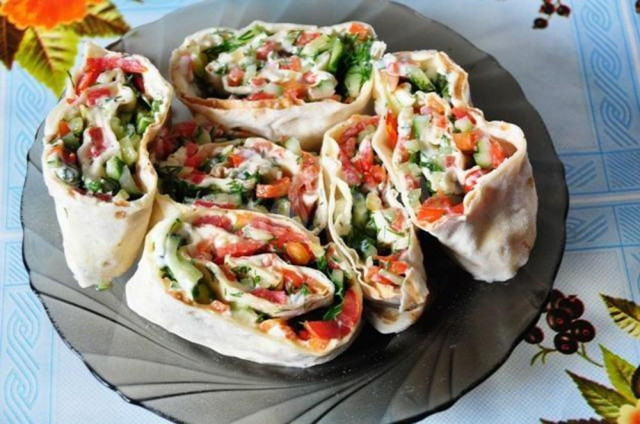Pita bread roll with herbs, cottage cheese and vegetables