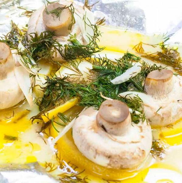 Appetizer in an envelope of mushrooms with lemon and garlic