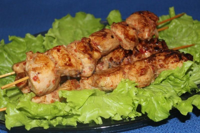 Chicken breasts on skewers in a frying pan