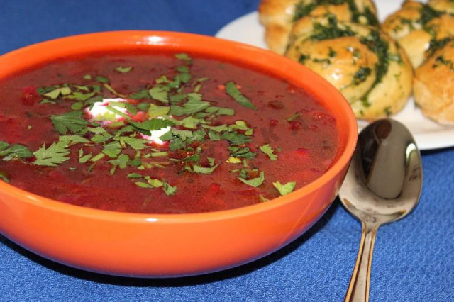 Borscht with beetroot tops and garlic buns