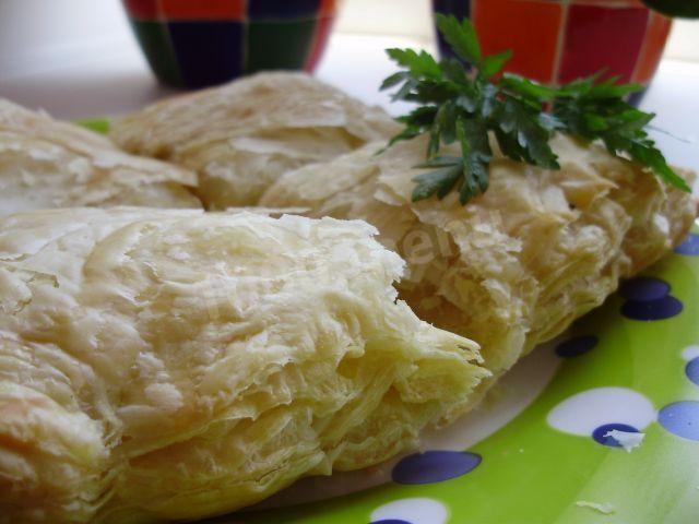 A simple pie with rice made from ready-made puff pastry