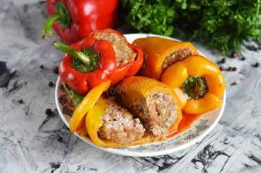 Stuffed peppers with tomato paste in a saucepan