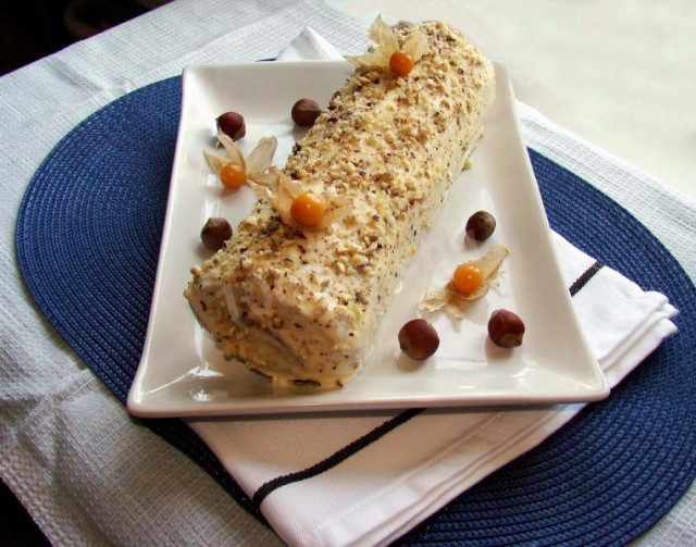 Sponge roll with cottage cheese filling and nuts