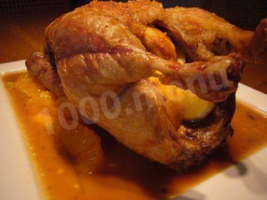 Whole baked duck in sauce with onions and citrus fruits