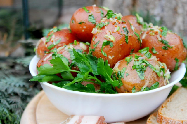 New potatoes with garlic in a uniform with fragrant dressing