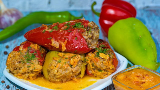 Stuffed peppers in sour cream and tomato sauce in the oven