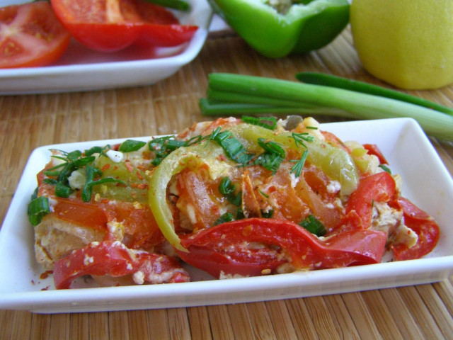 Pink salmon with tomatoes and onions in foil in the oven