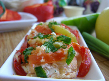 Pink salmon with tomatoes and onions in foil in the oven