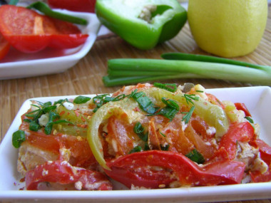 Pink salmon with tomatoes and onions in foil in the oven