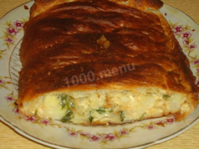 Pie with potatoes, cream, onions and cheese in the oven