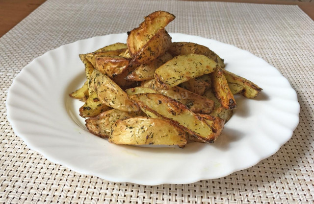 Rustic potatoes with herbs and garlic in the oven