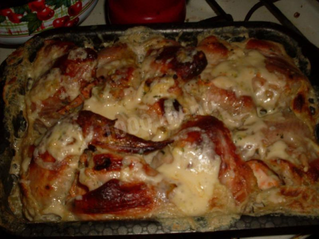 potatoes with chicken wings and cheese in the oven