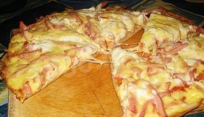 Pizza with yeast dough and milk in the oven