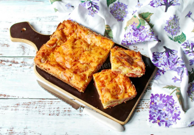 Aspic pie with sausages and grated cheese on kefir