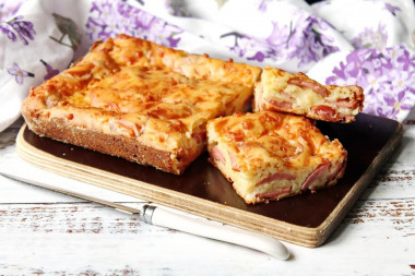 Aspic pie with sausages and grated cheese on kefir