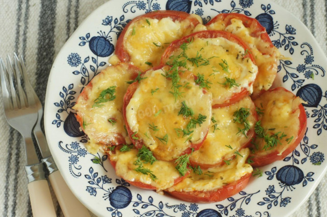 Baked tomatoes under a cheese cap with mayonnaise