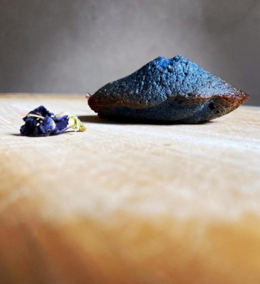 Madeleine flower cookies with blue tea on almond flour