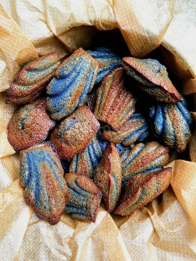 Madeleine flower cookies with blue tea on almond flour