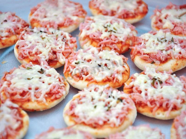 Mini pizza with ham and cheese on a ready-made puff pastry