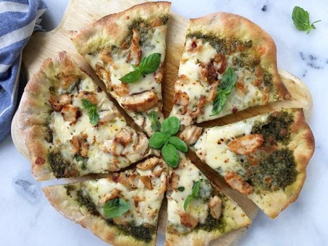 Pizza made from dough on milk with chicken and pesto sauce