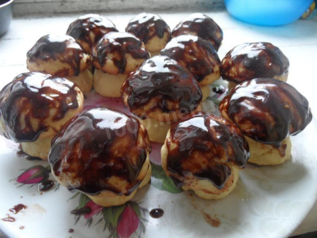 Cookies mushrooms on sour cream in chocolate glaze
