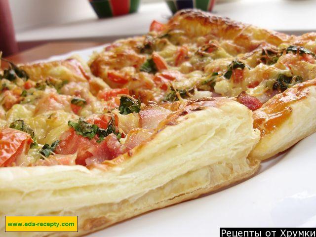 Puff pastry pizza with sausages and hard cheese