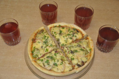 Italian thin pizza with ham, cheese and mushrooms