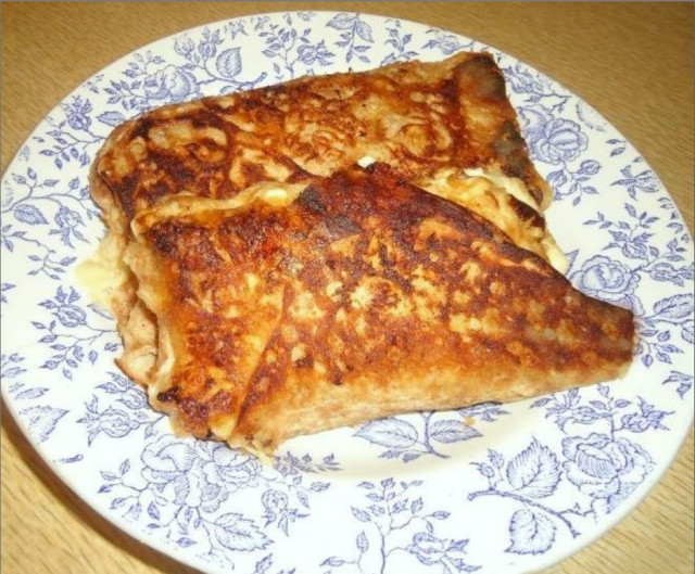 Pita bread khachapuri in a pan with cheese, kefir and egg