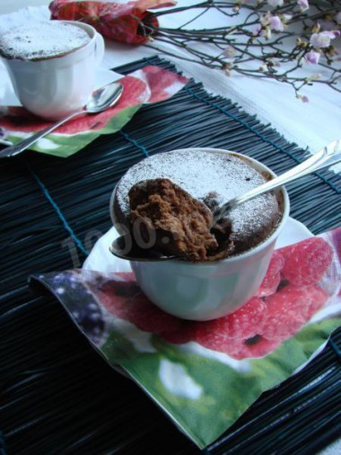 Chocolate cupcake in a mug in the microwave for 3 minutes