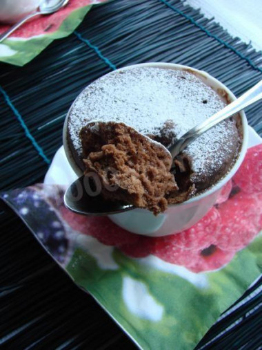 Chocolate cupcake in a mug in the microwave for 3 minutes