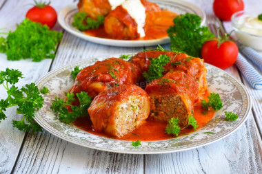 Frozen cabbage rolls in a saucepan with tomato paste