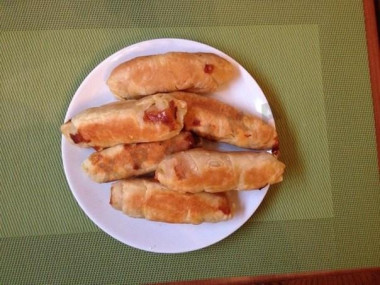 Sausages in dough in a slow cooker in puff pastry